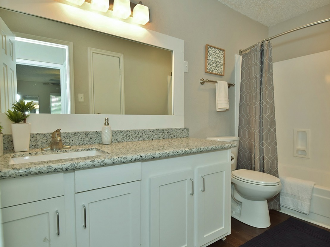 Model bathroom with tub shower combination at Oakbrook Apartments