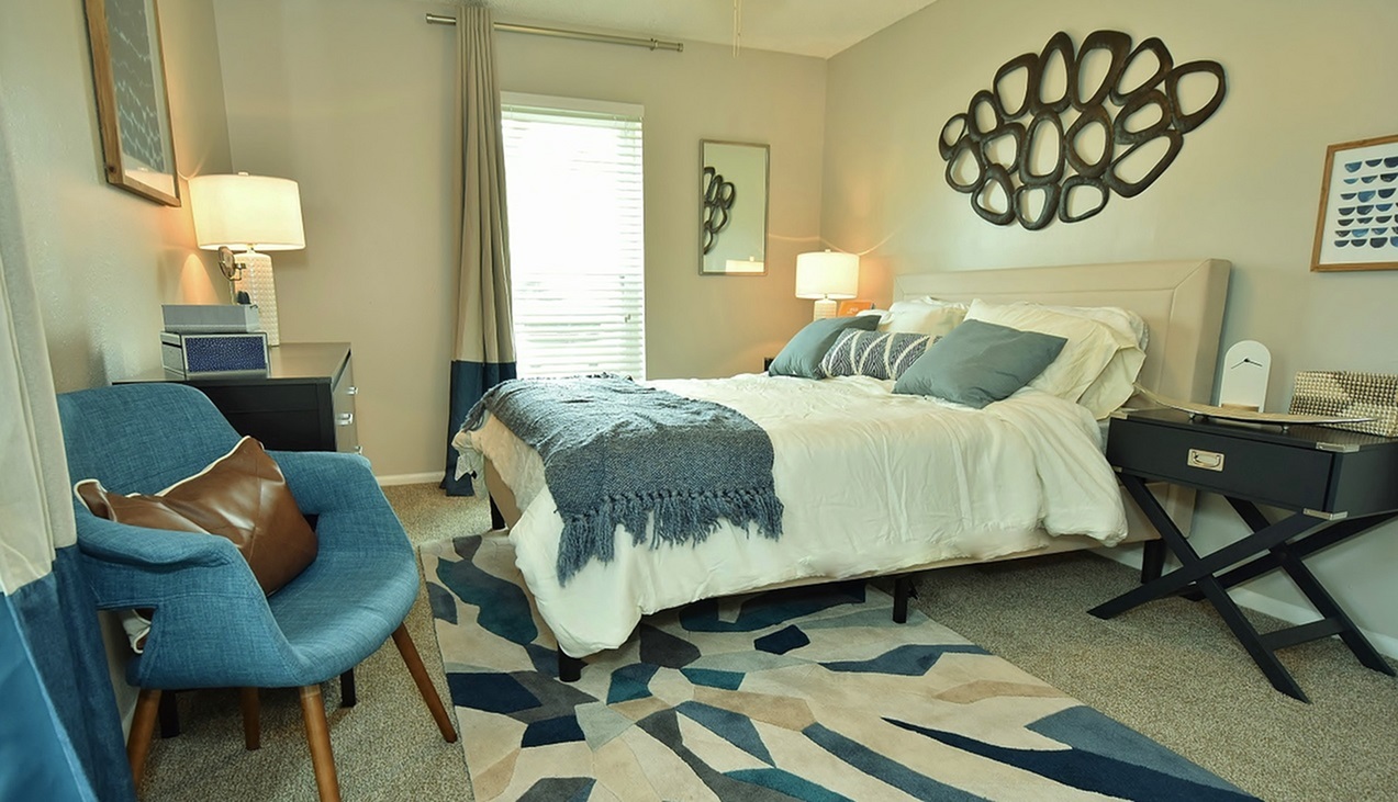 Model bedroom with plush carpeting at Oakbrook Apartments