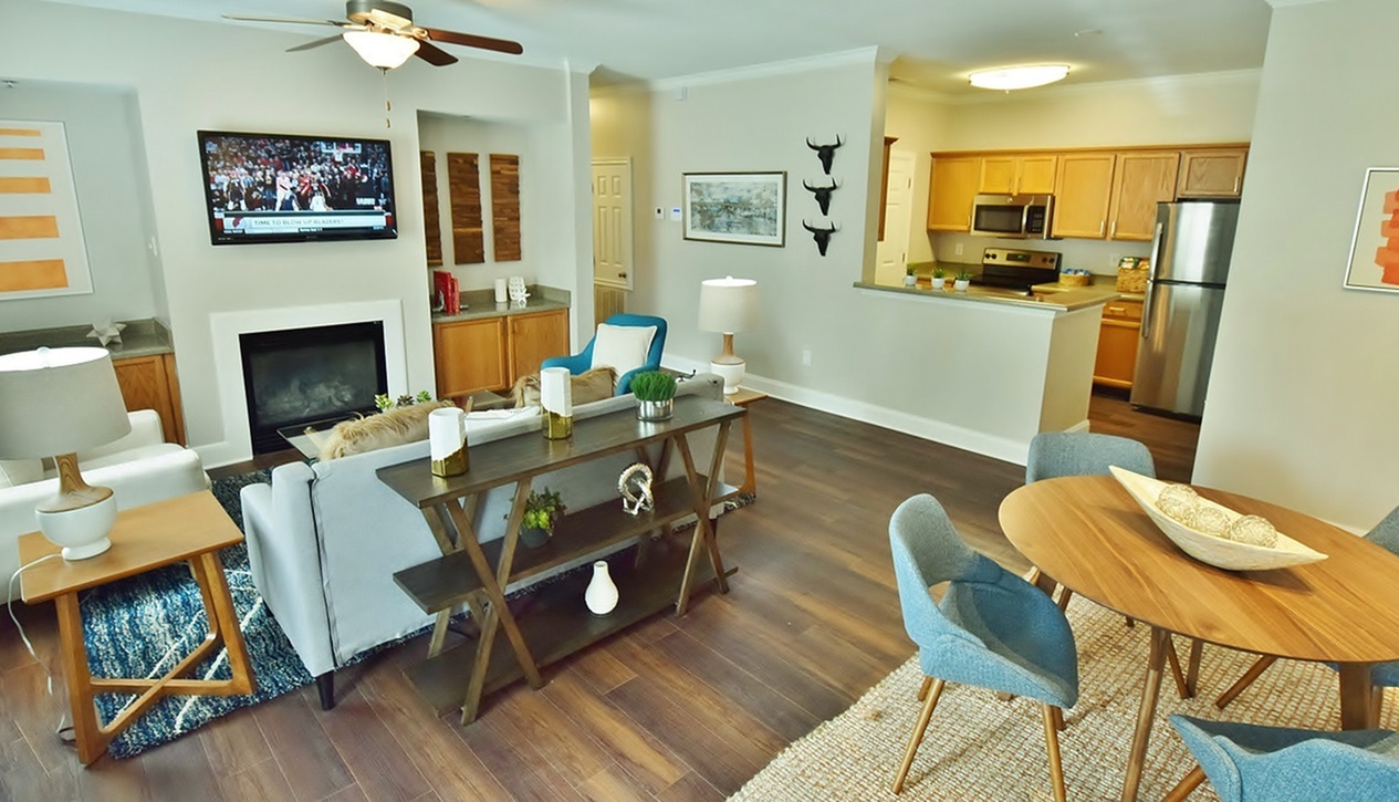 Model living room with a fireplace and ceiling fan
