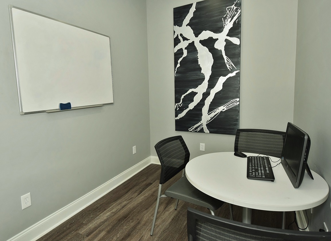 Private meeting room with a whiteboard at Oakbrook Apartments